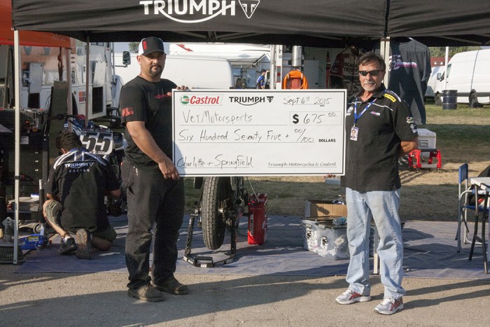 Bill Gately presenting injured warfighter Matt with a check from Castrol-Triumph for the VETMotorsports Performance Matching Fund.